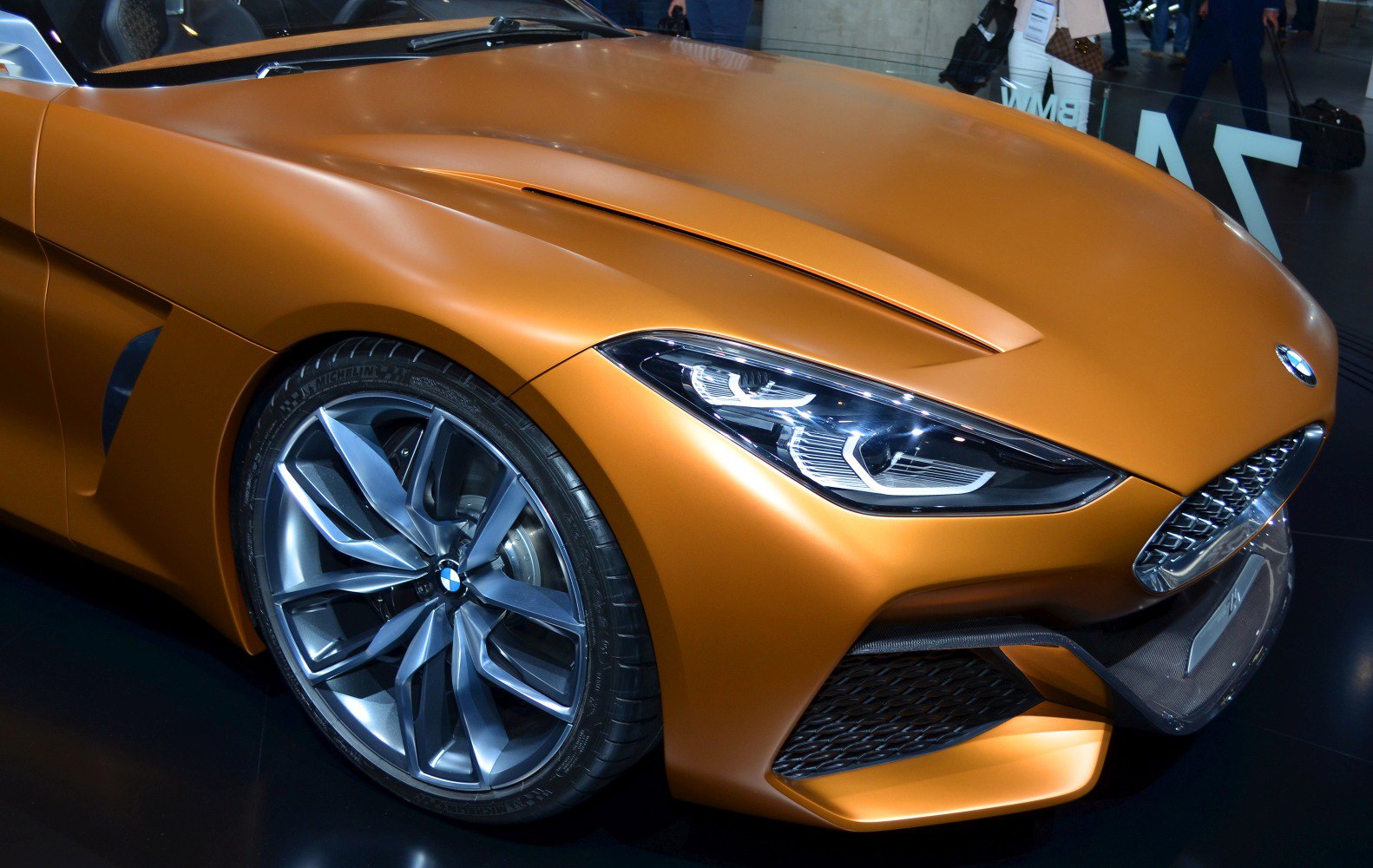 Front close-up with sharp headlights and alloy wheel