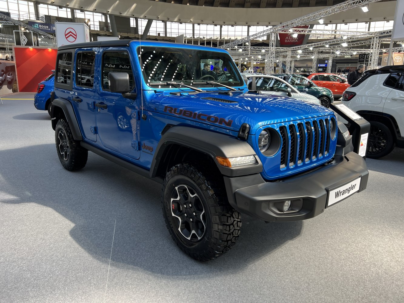Blue off-road SUV with rugged tires and classic grille design