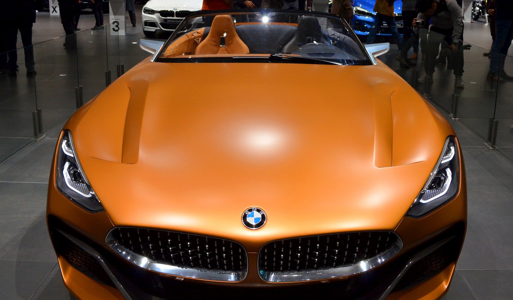 Matte orange hood, LED headlights, and kidney grille front view