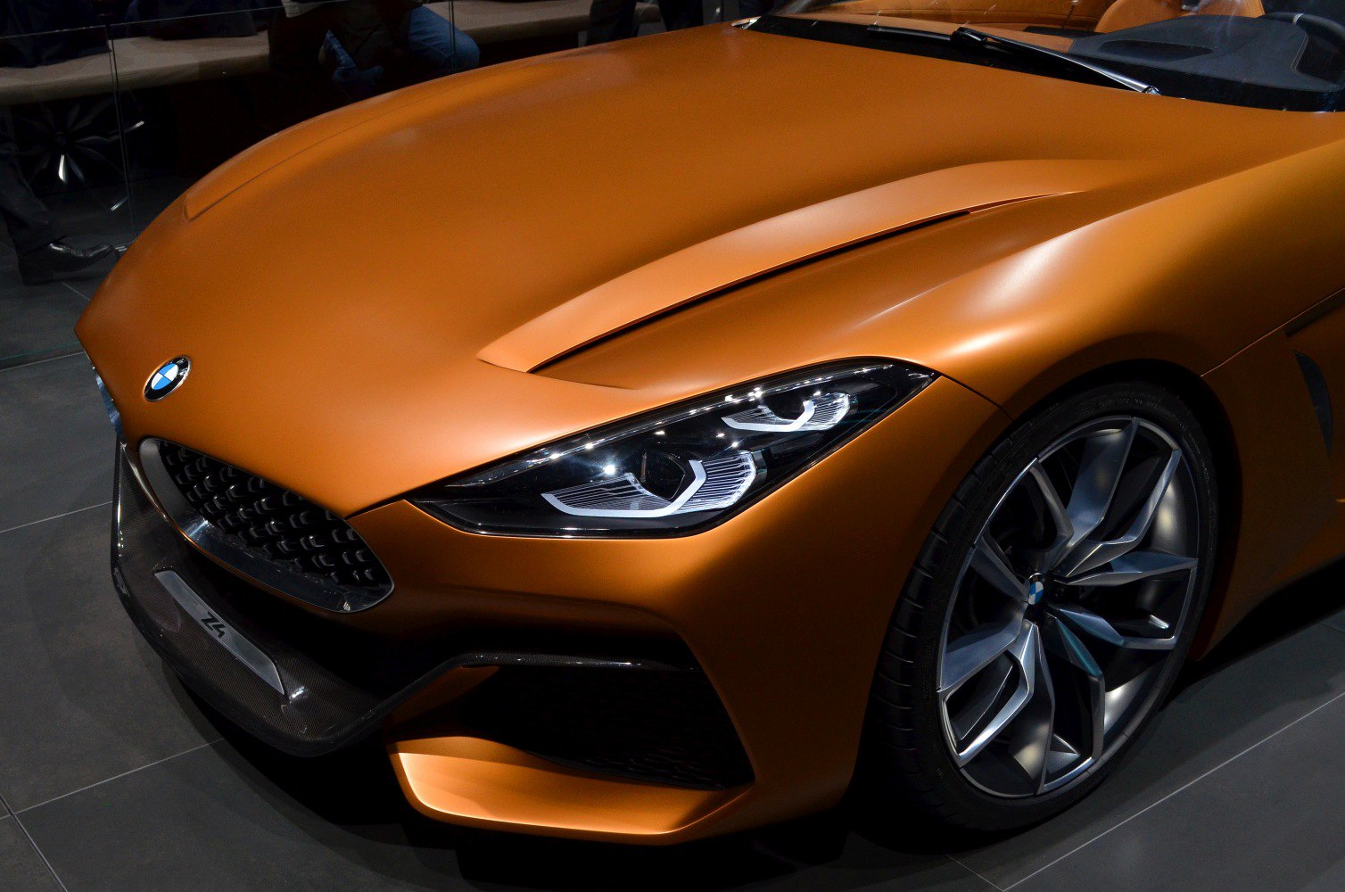 Close-up of sleek front headlight and alloy wheel design