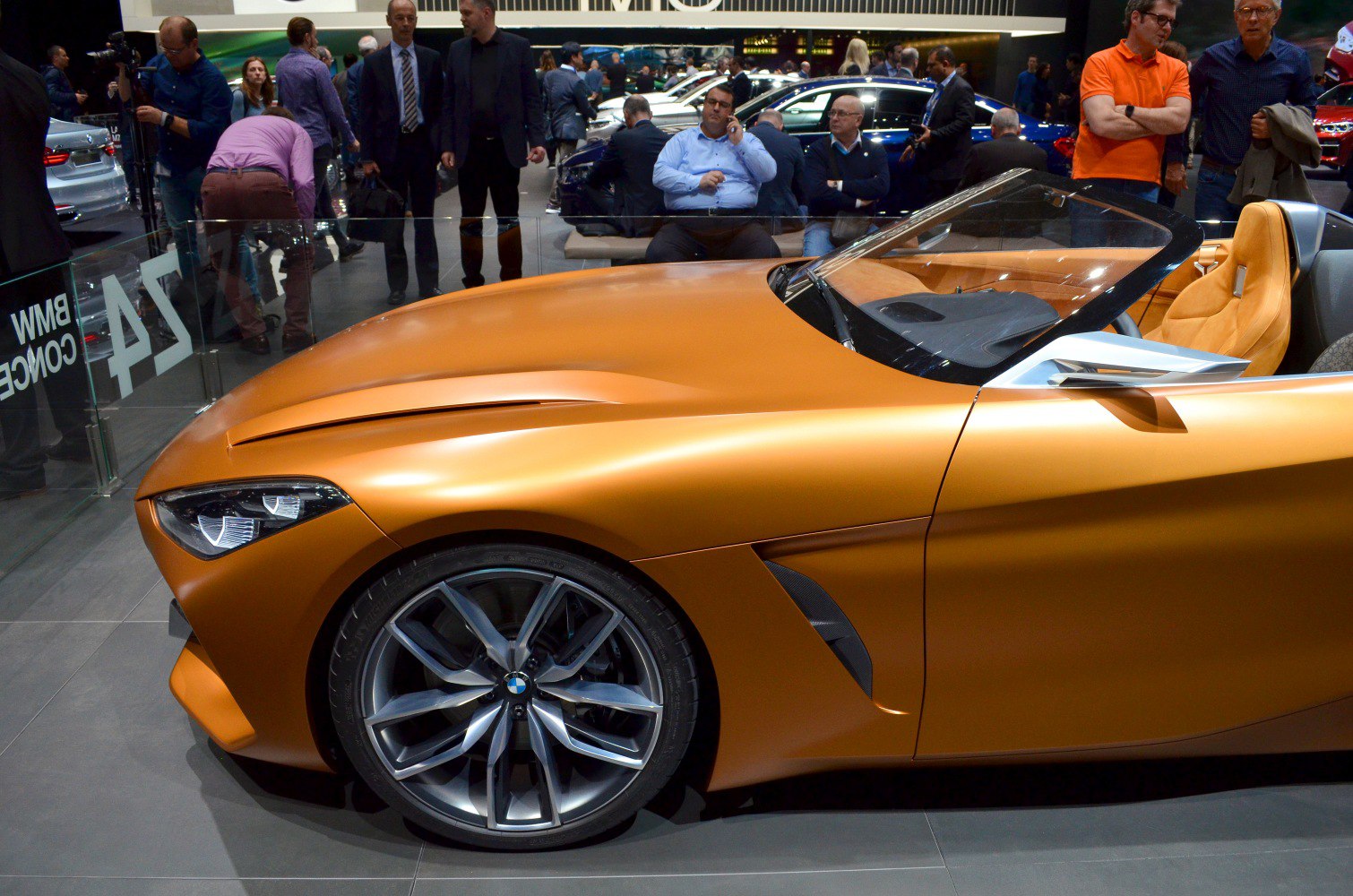 Close-up of front fender, alloy wheel and headlight on a sleek convertible.