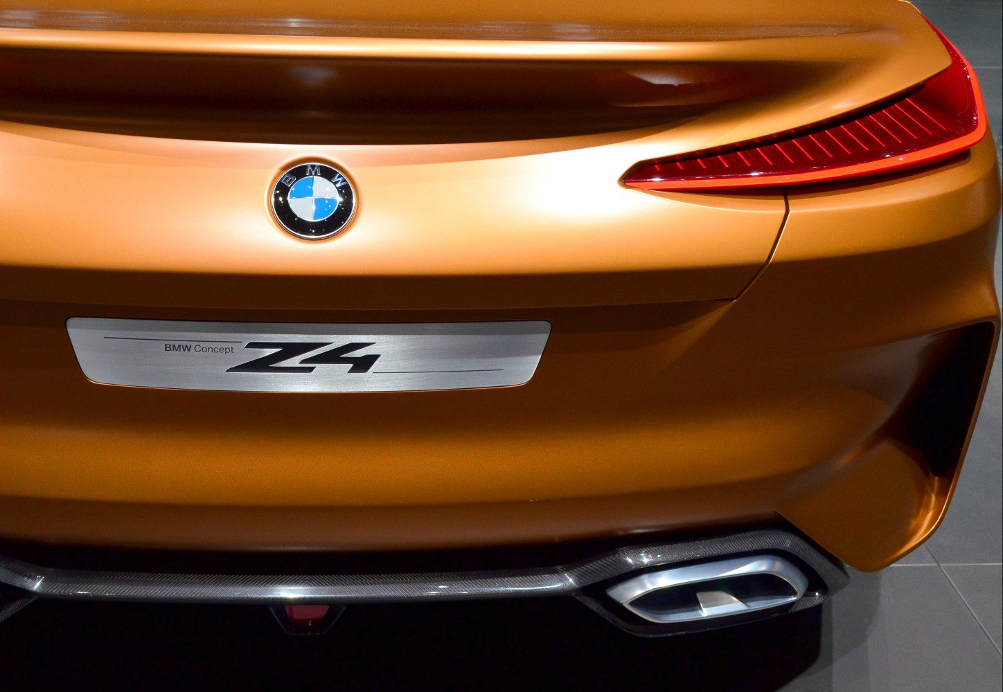 Sleek rear design with tail light and exhaust detail