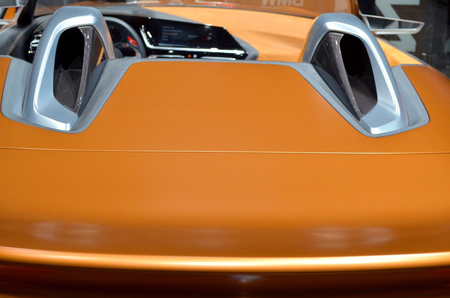 Rear roll hoops and digital dashboard inside a sporty roadster