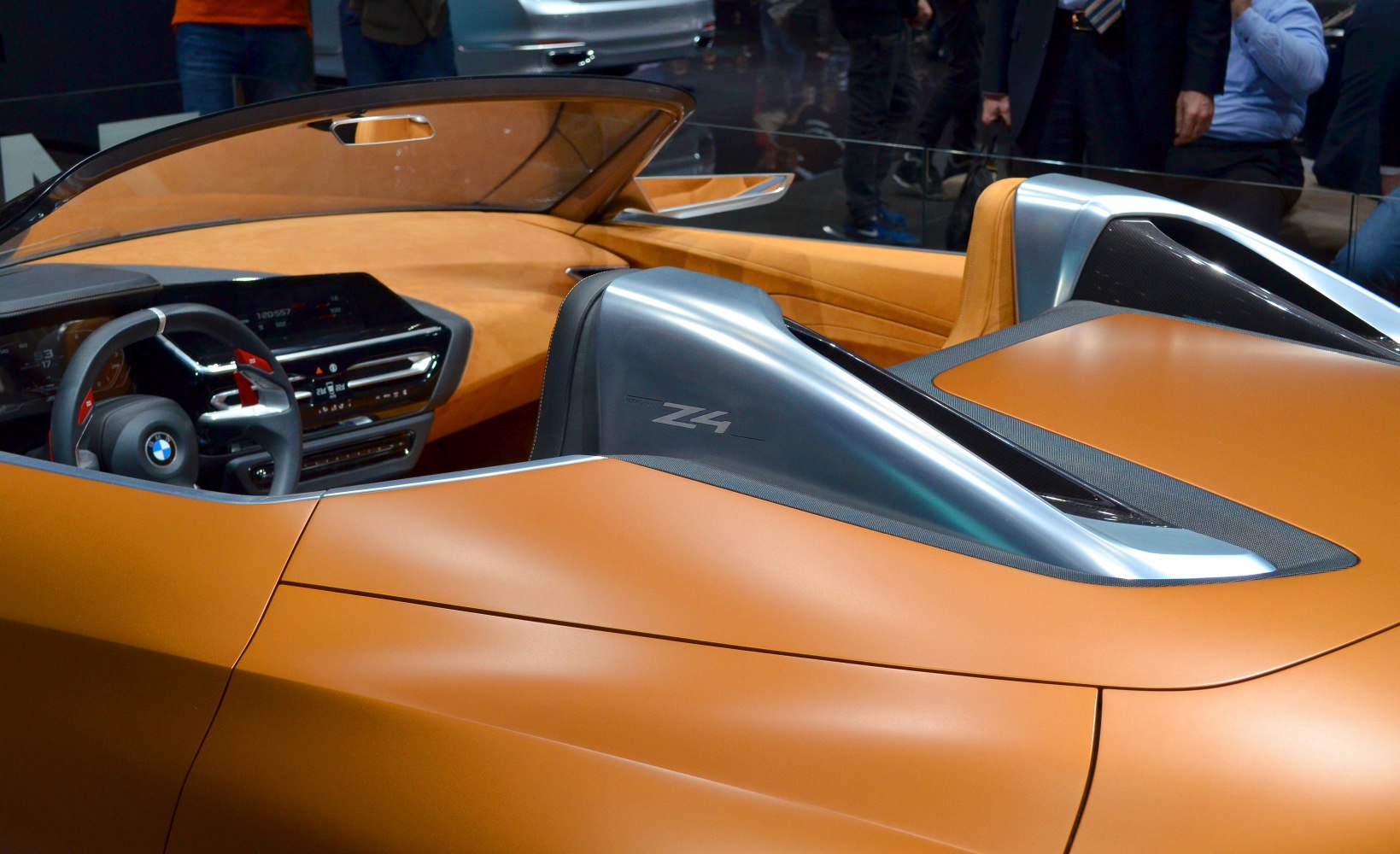 Interior view with tan leather and metallic rear roll hoops
