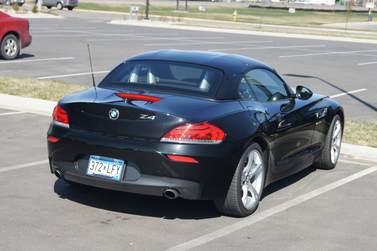 Rear view of sports roadster with soft top and distinctive taillights