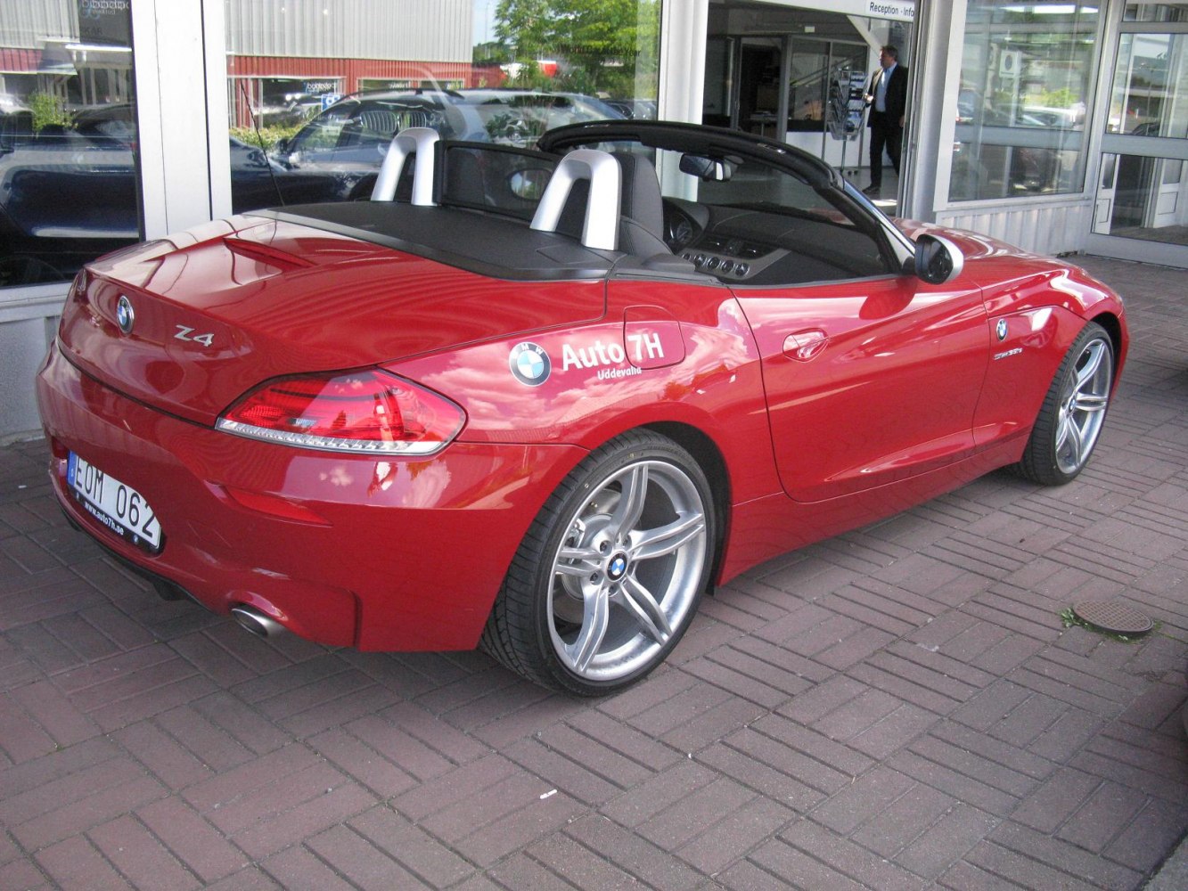 Red convertible with alloy wheels and sleek rear side design