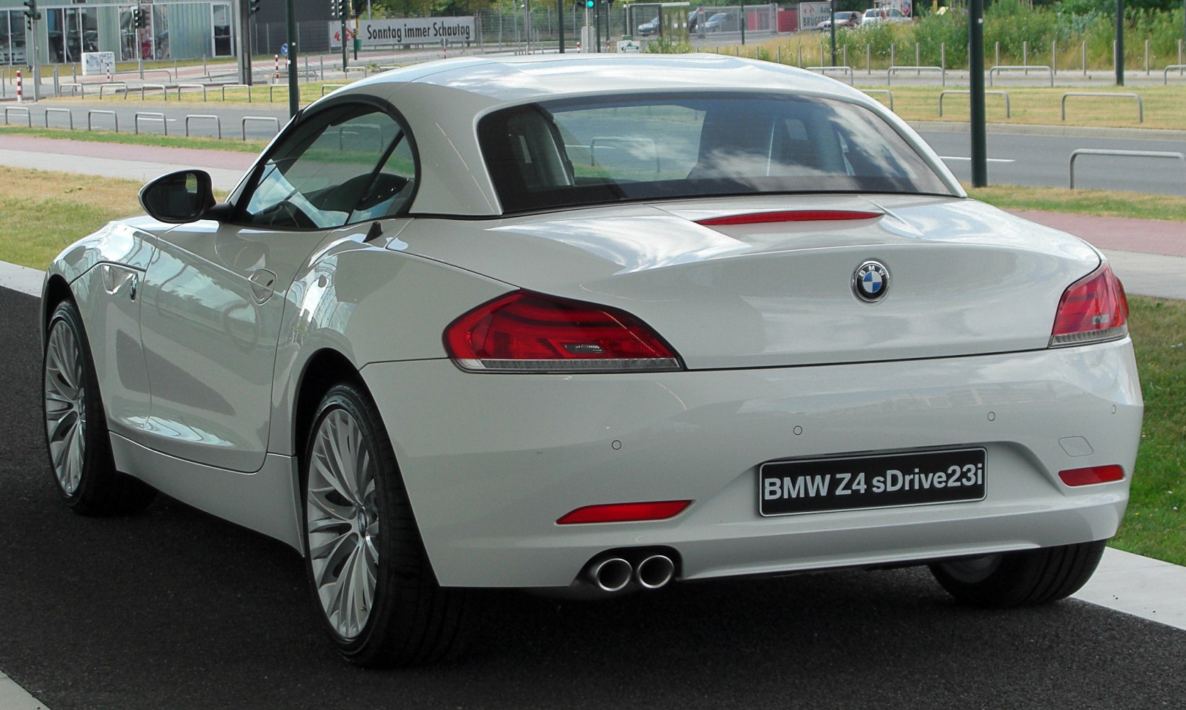 Rear view with dual exhaust pipes and sleek taillights