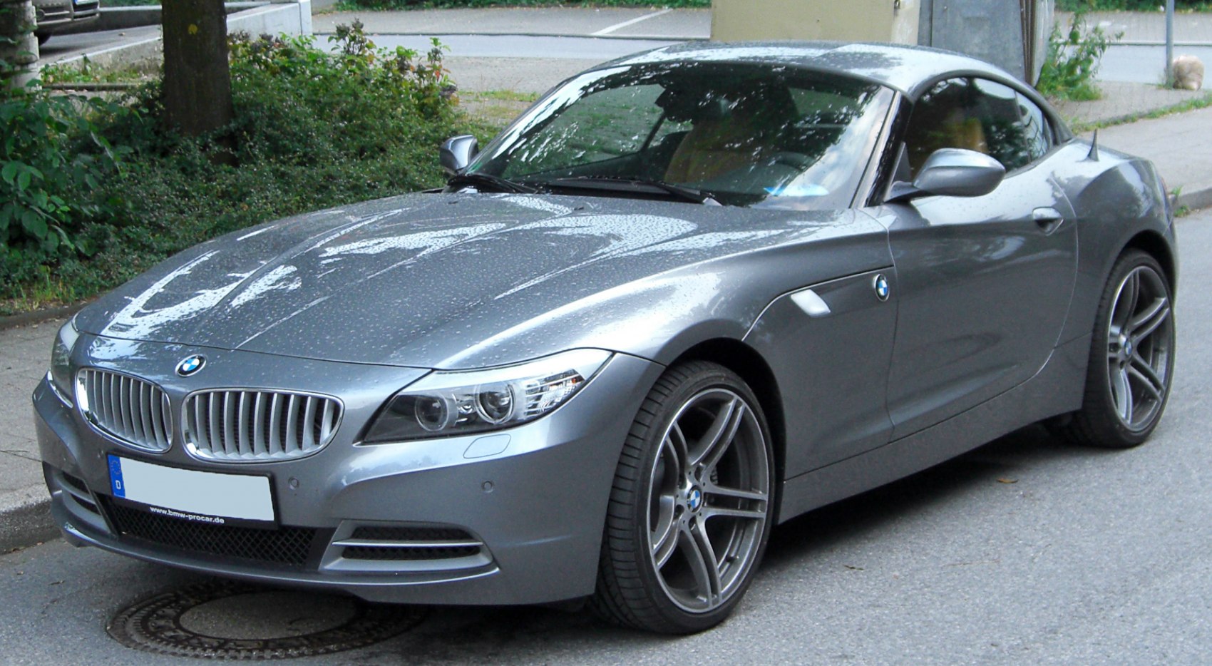 Front side view of a sleek sporty coupe with alloy wheels.