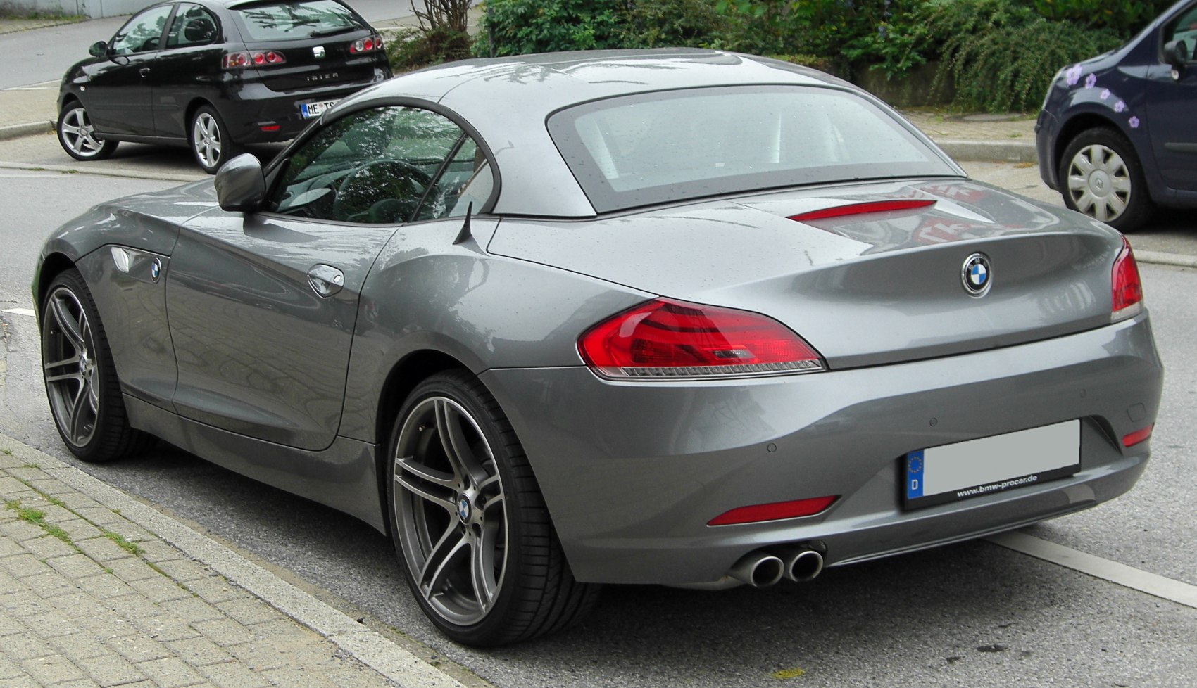 Rear view of sporty coupe with dual exhaust and integrated spoiler