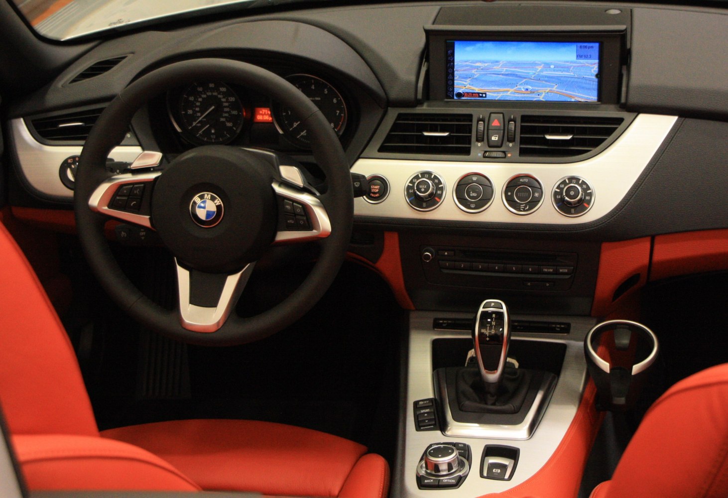 Dashboard and navigation system with red leather seats