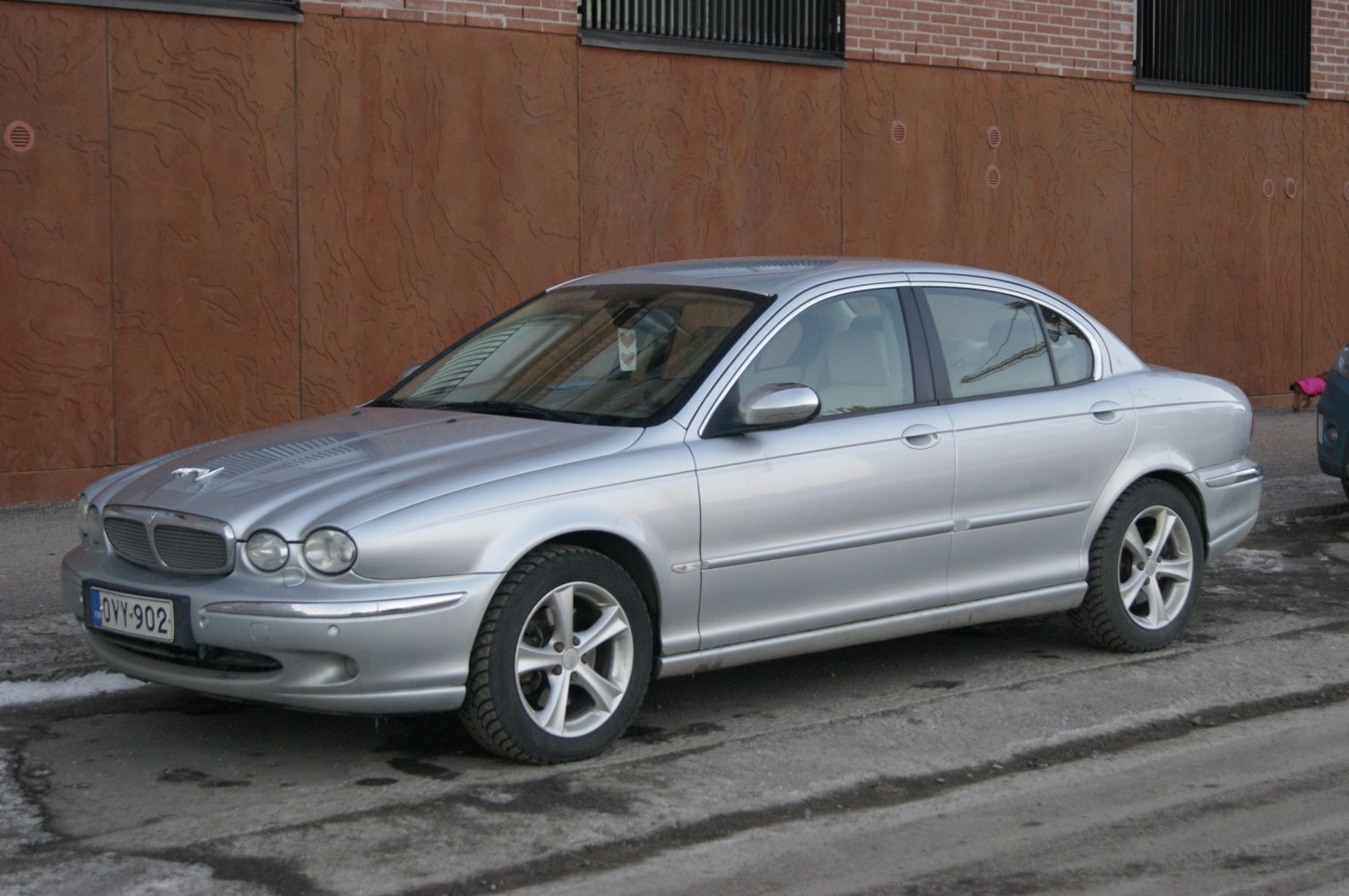 Silver luxury sedan with round headlights and smooth body lines.