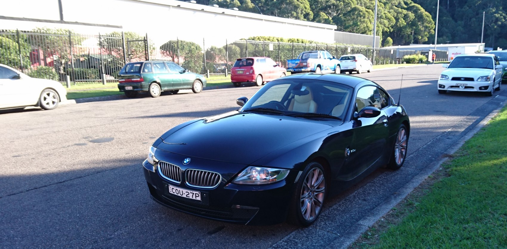 Front side view of a sleek black sports coupe with alloy wheels