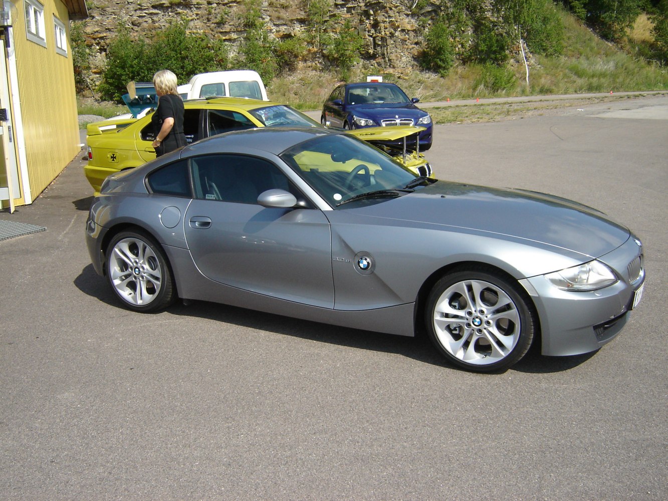 Silver coupe with sleek body and alloy wheels side view