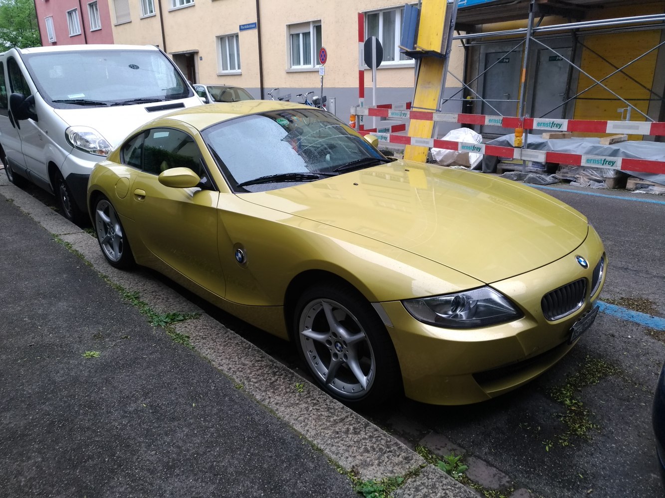 Gold two-door coupe with sporty alloy wheels and aerodynamic design