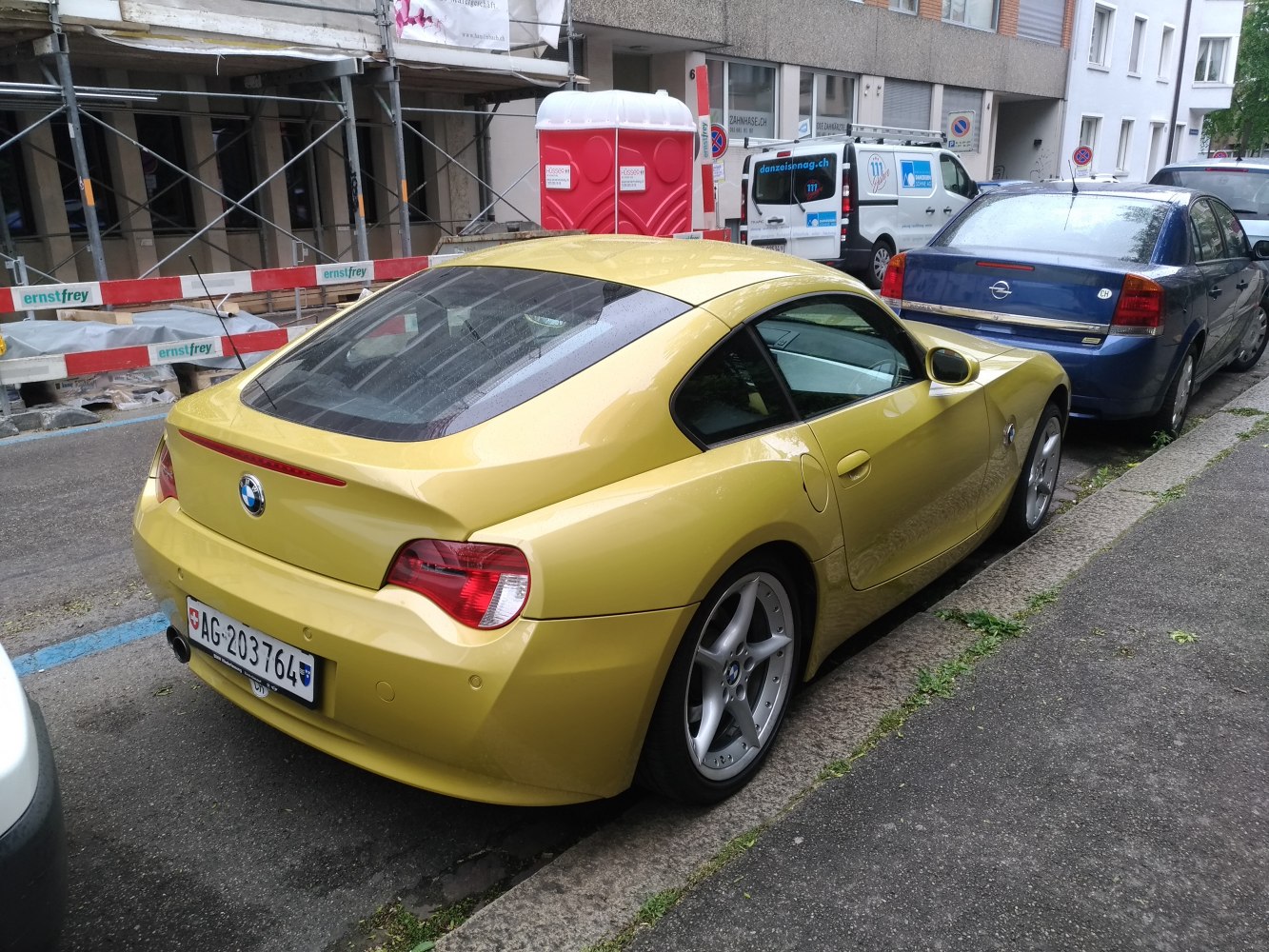 Yellow two-door coupe rear and side view with alloy wheels