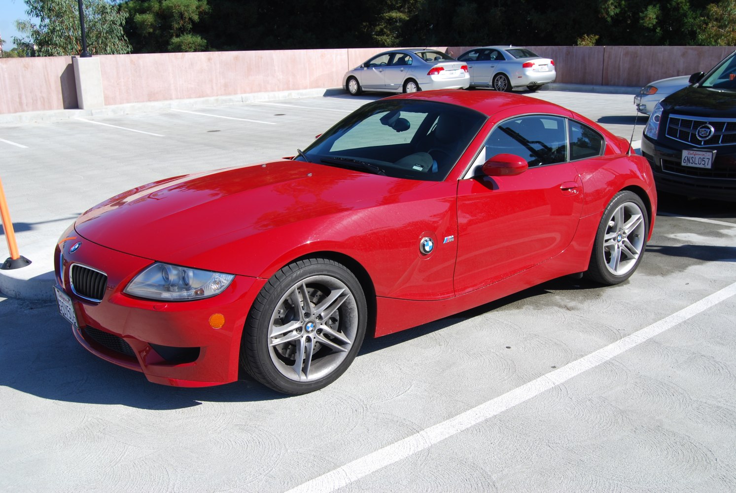 Red coupe with alloy wheels and sleek sporty design front side view