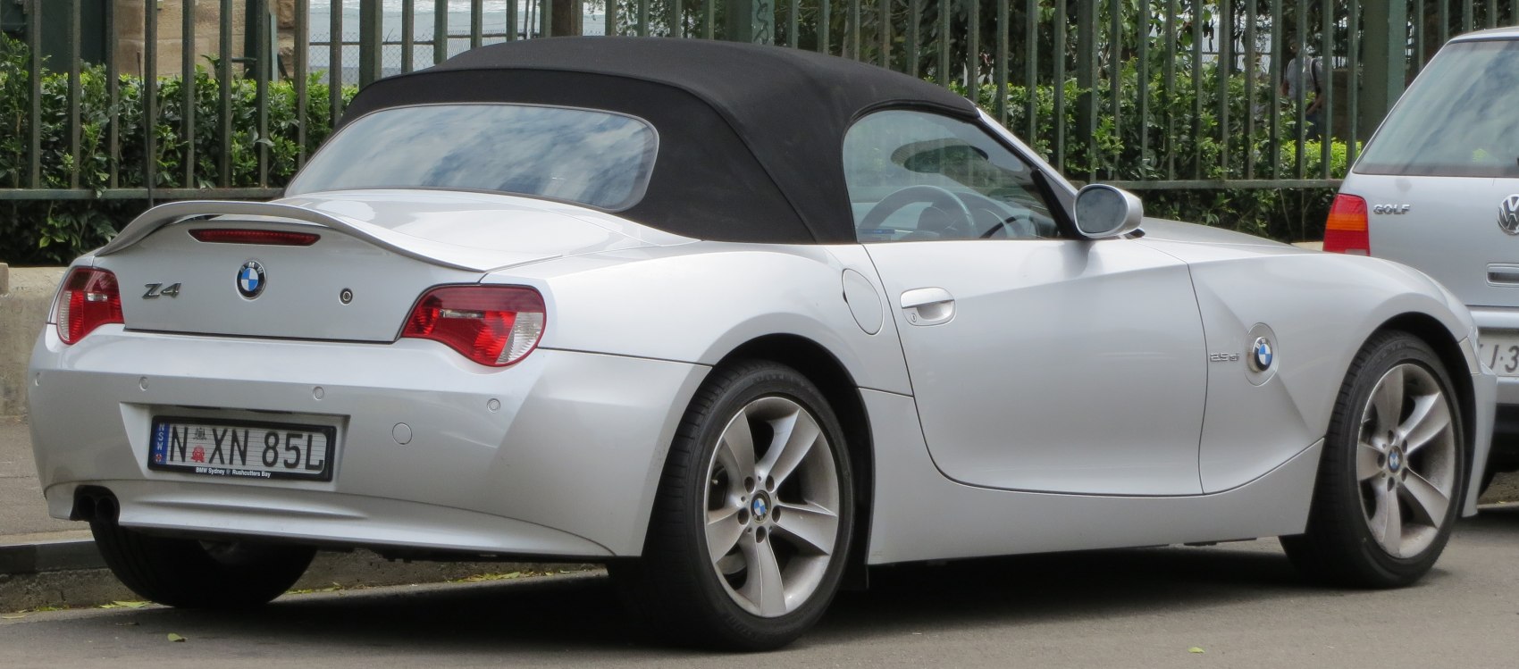 Rear view of soft top convertible with distinct taillights and alloy wheels