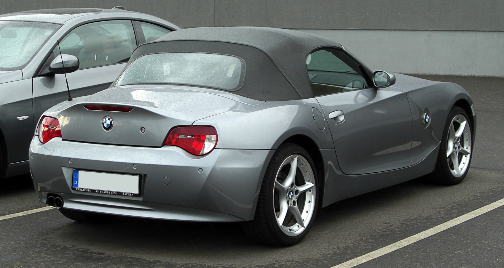 Rear view of convertible with soft top and sporty alloy wheels