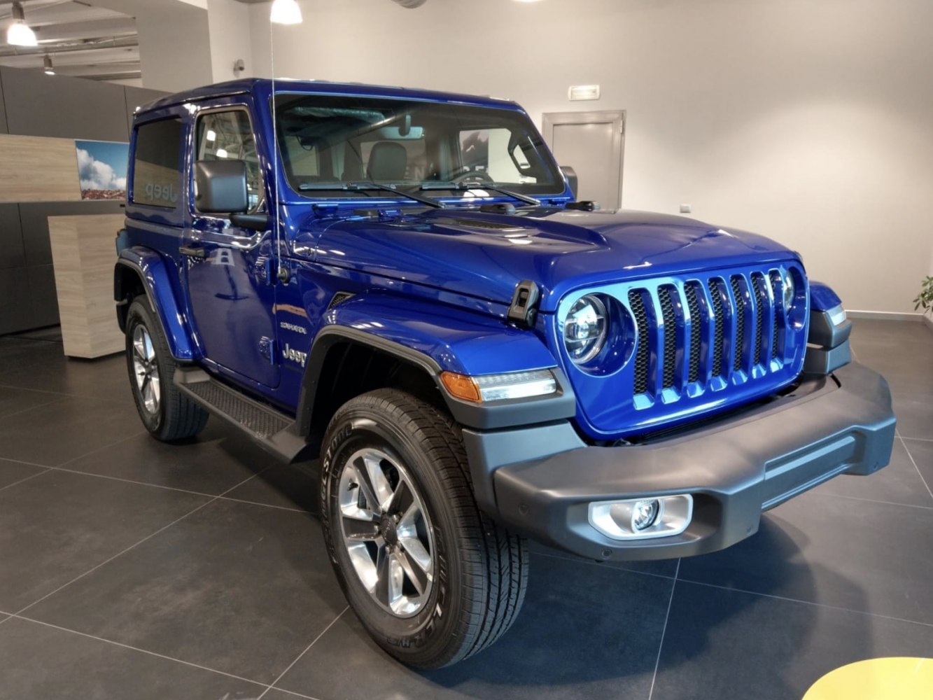 Blue SUV with seven-slot grille and round headlights
