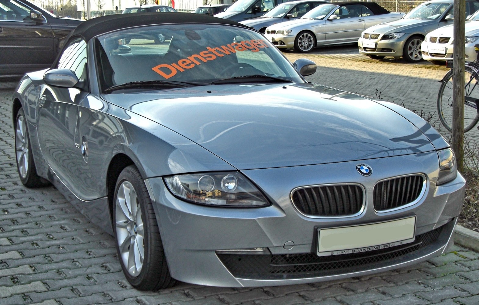 Sporty front view of a silver roadster with kidney grille and sharp headlights
