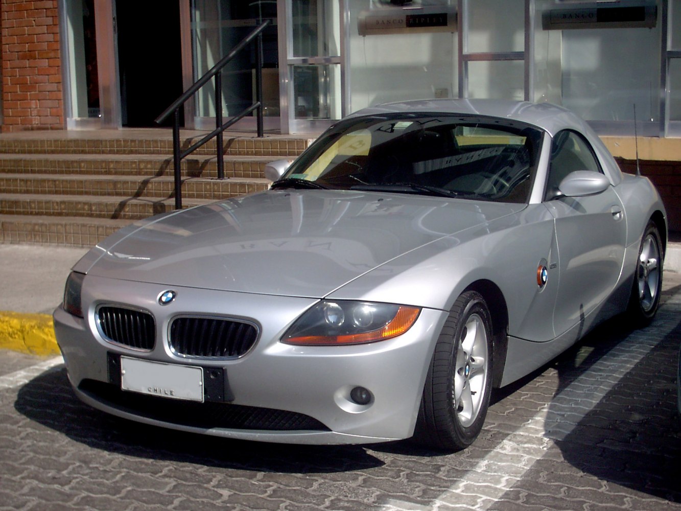 Silver sports convertible front angled view with headlights and alloy wheels