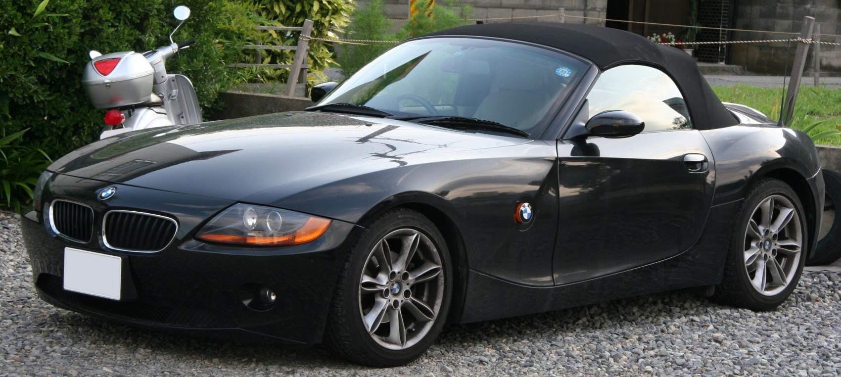 Front side view of a soft top convertible roadster with alloy wheels
