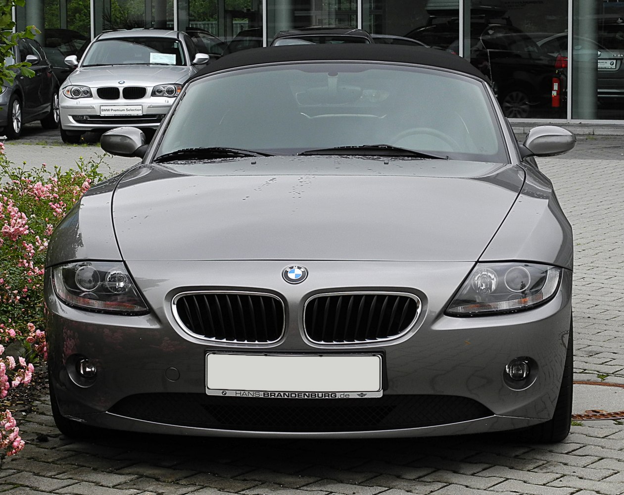 Front view with kidney grille and dual round headlights, convertible top visible
