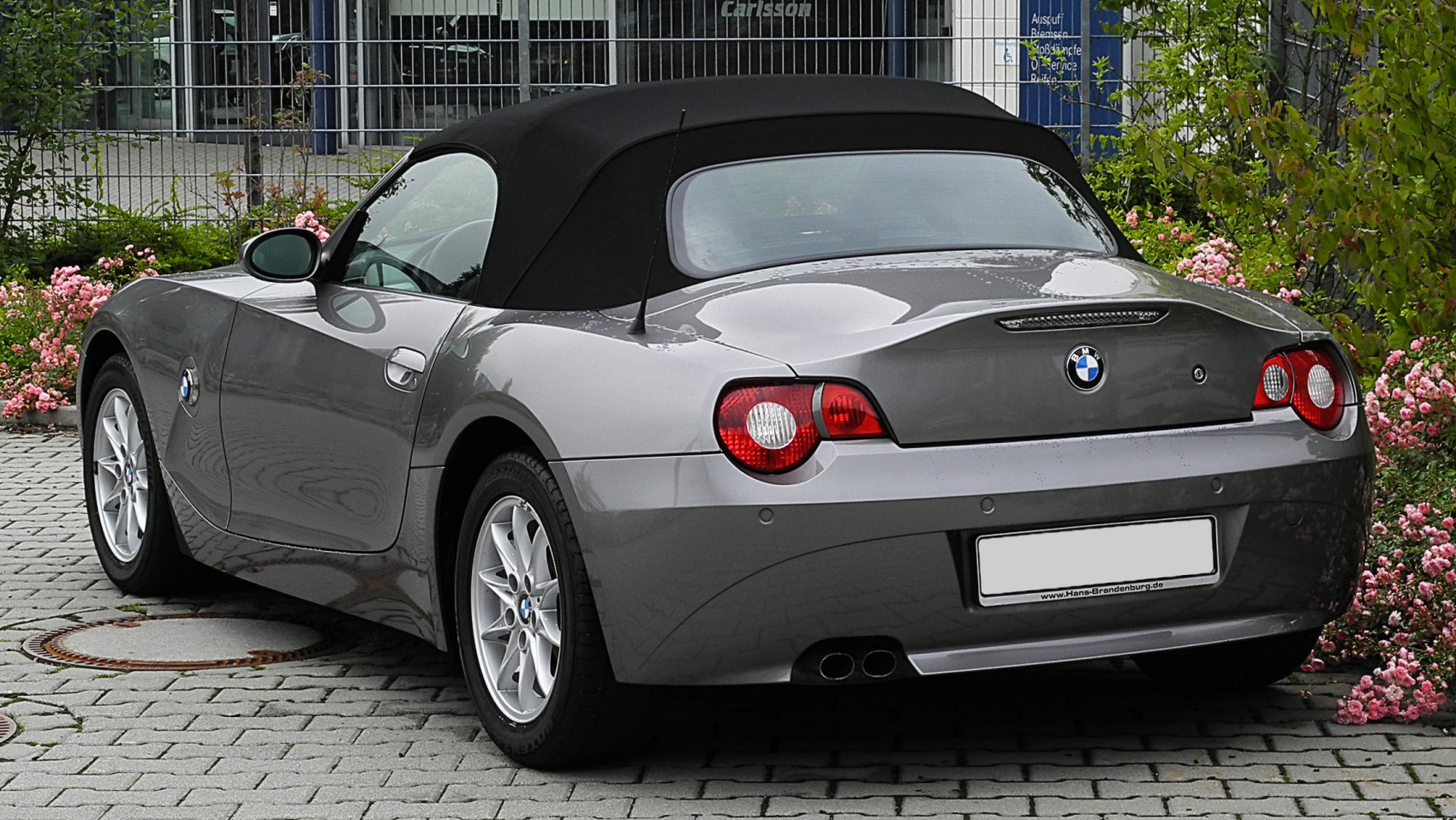 Convertible with black soft top and rounded rear taillights