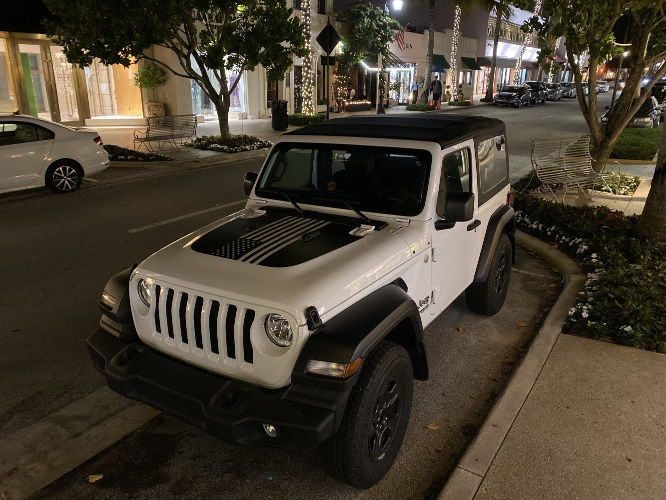Soft top Jeep Wrangler JL with hood decal at night