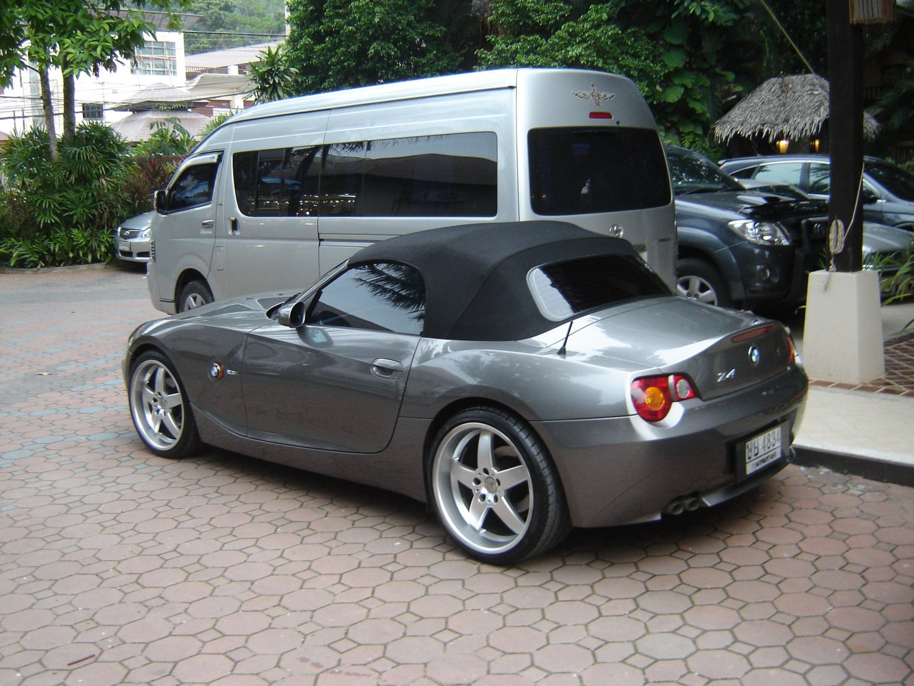 Convertible sports car with soft top and alloy wheels.
