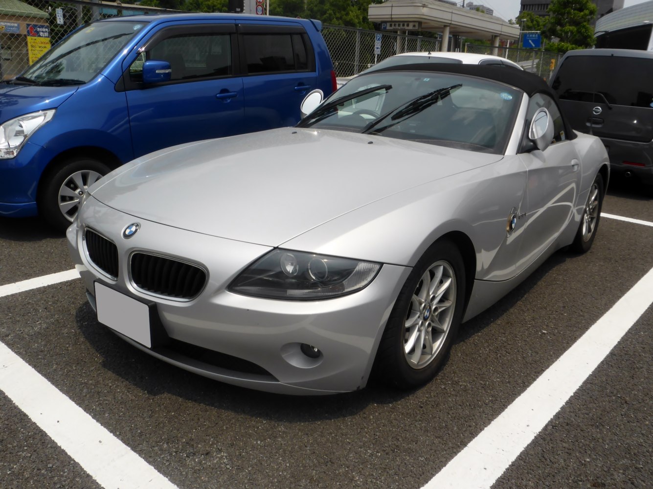 Silver convertible with sleek headlights and sporty front-side design