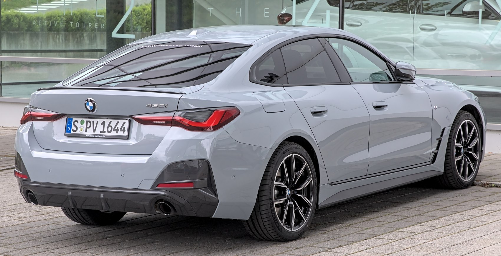 Rear and side view of a modern sporty sedan with distinctive taillights.