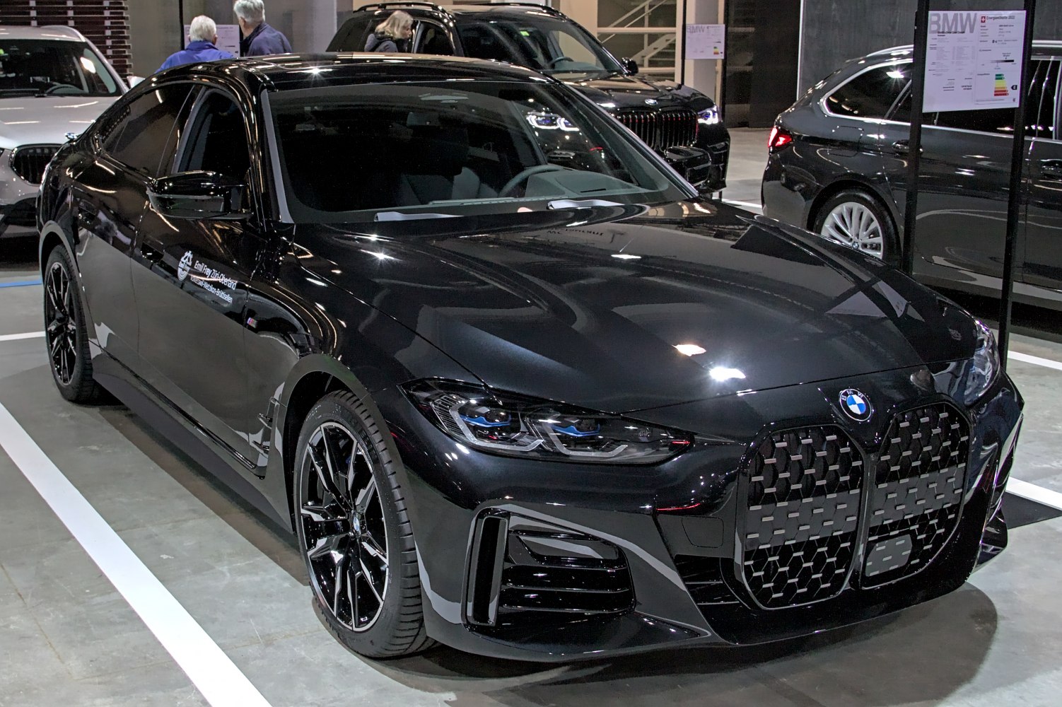 Black luxury gran coupe with bold front grille and LED headlights