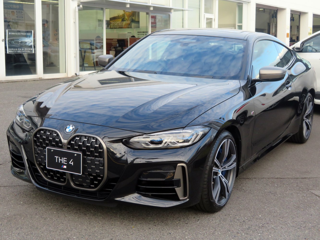 Large kidney grille and sleek LED headlights on sporty coupe front