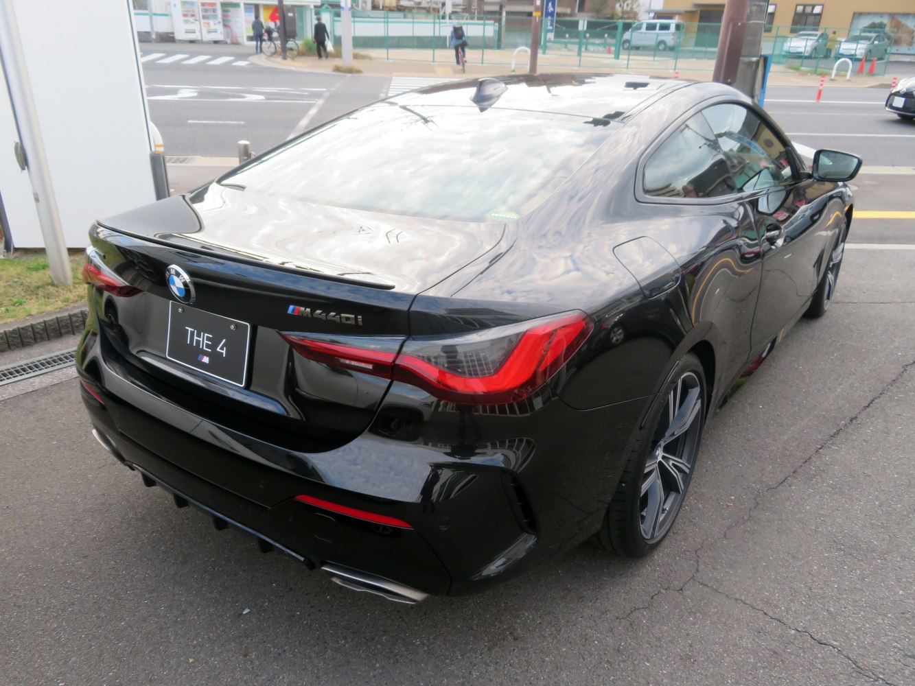 Rear view with tail lights and dual exhaust of a luxury coupe