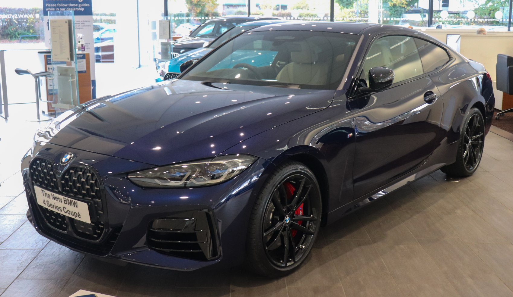 Front side view with sleek headlights and black alloy wheels