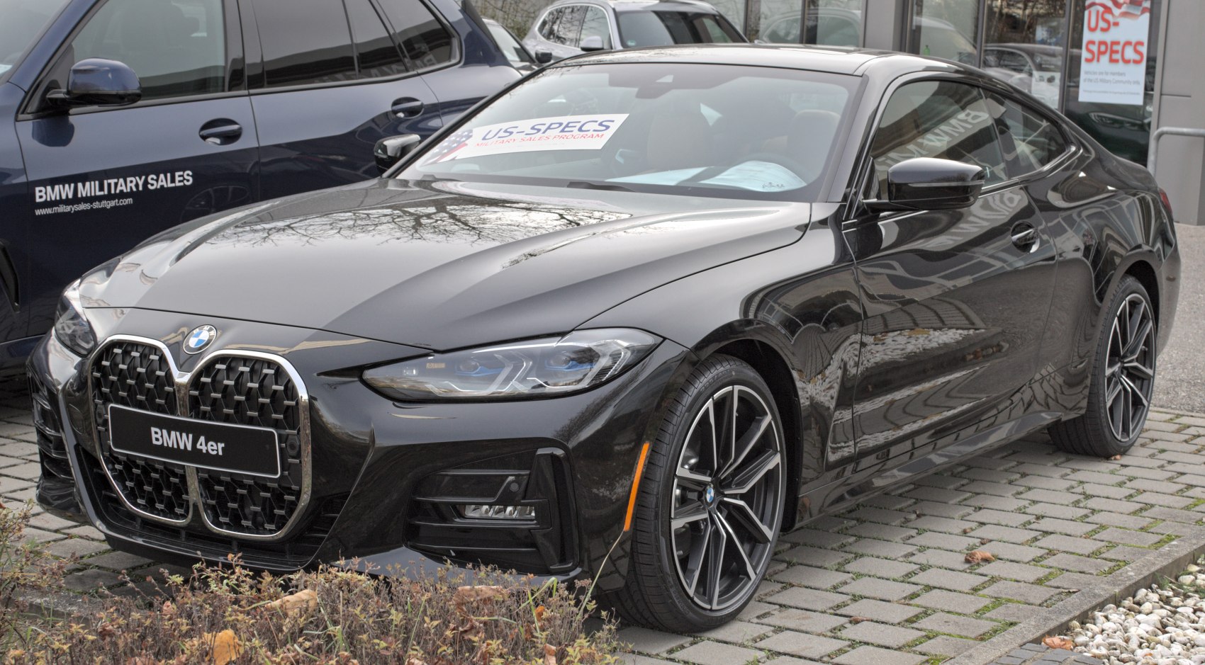 Sporty front view with large kidney grille and sleek headlights
