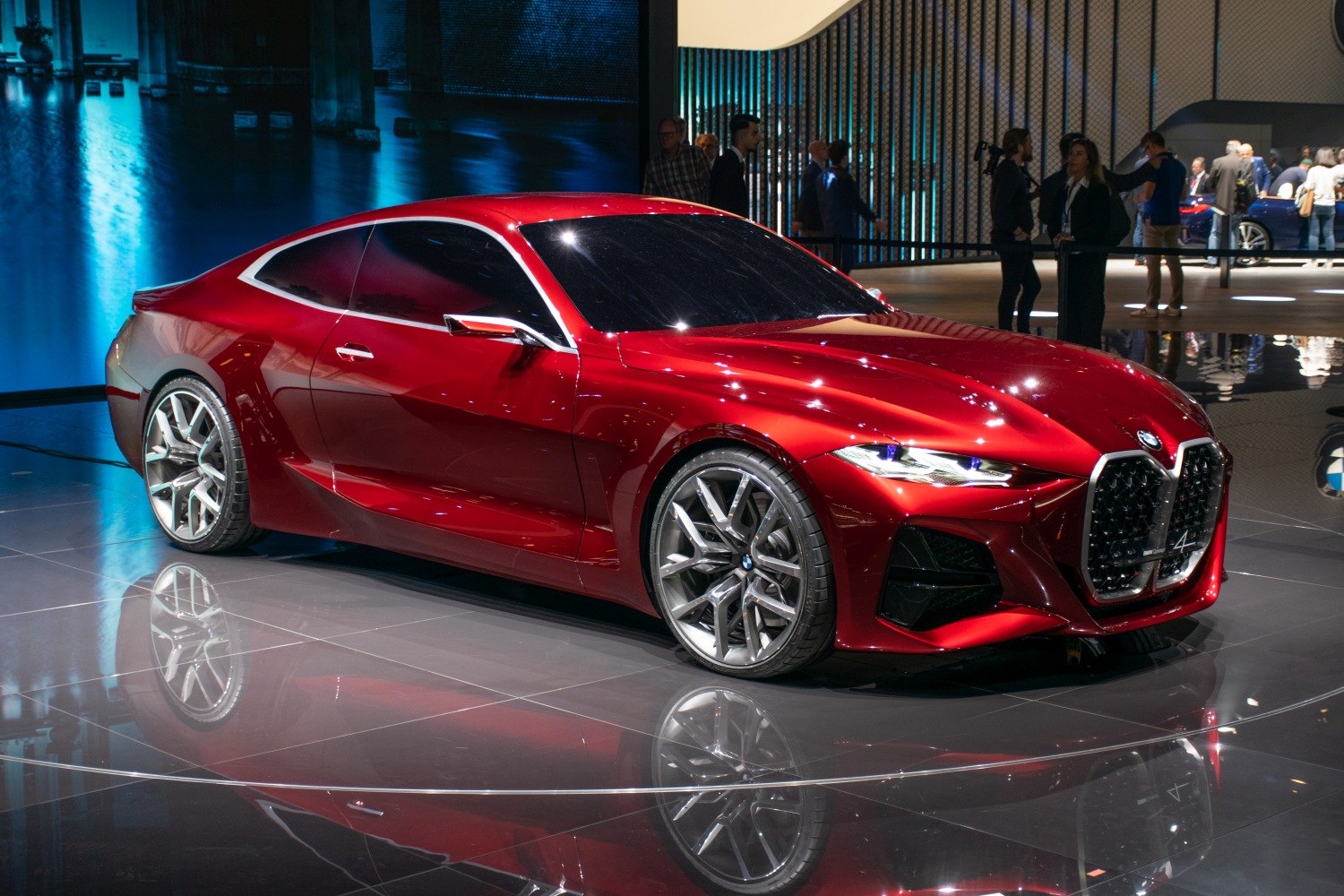 Red sports coupe with large kidney grille and alloy wheels