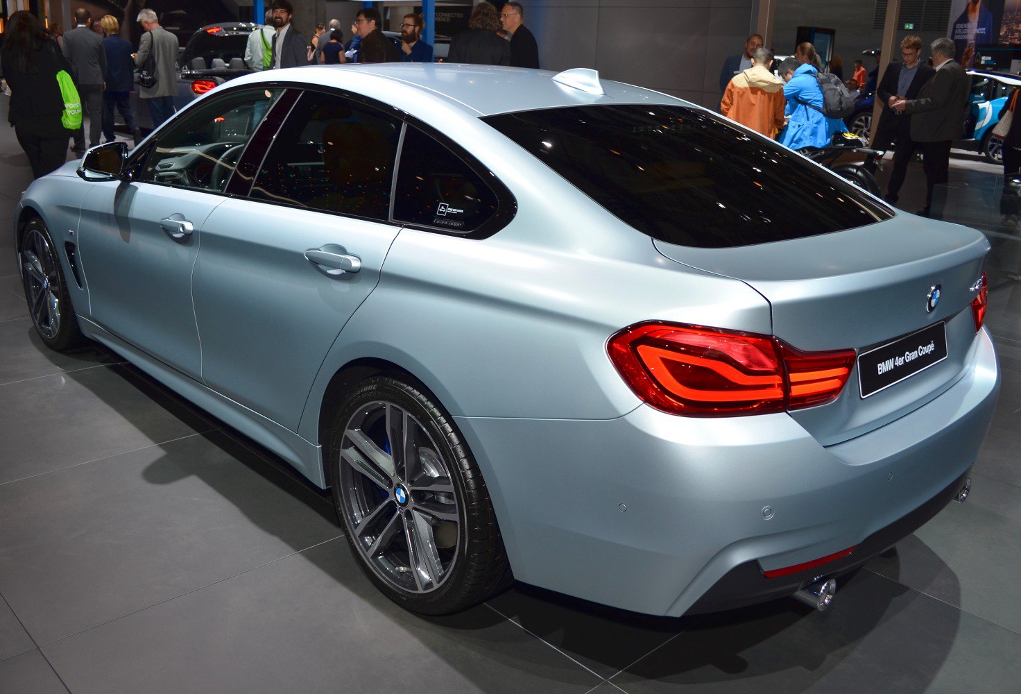 Rear and side view of a sleek metallic luxury sedan with distinct taillights and dual exhausts