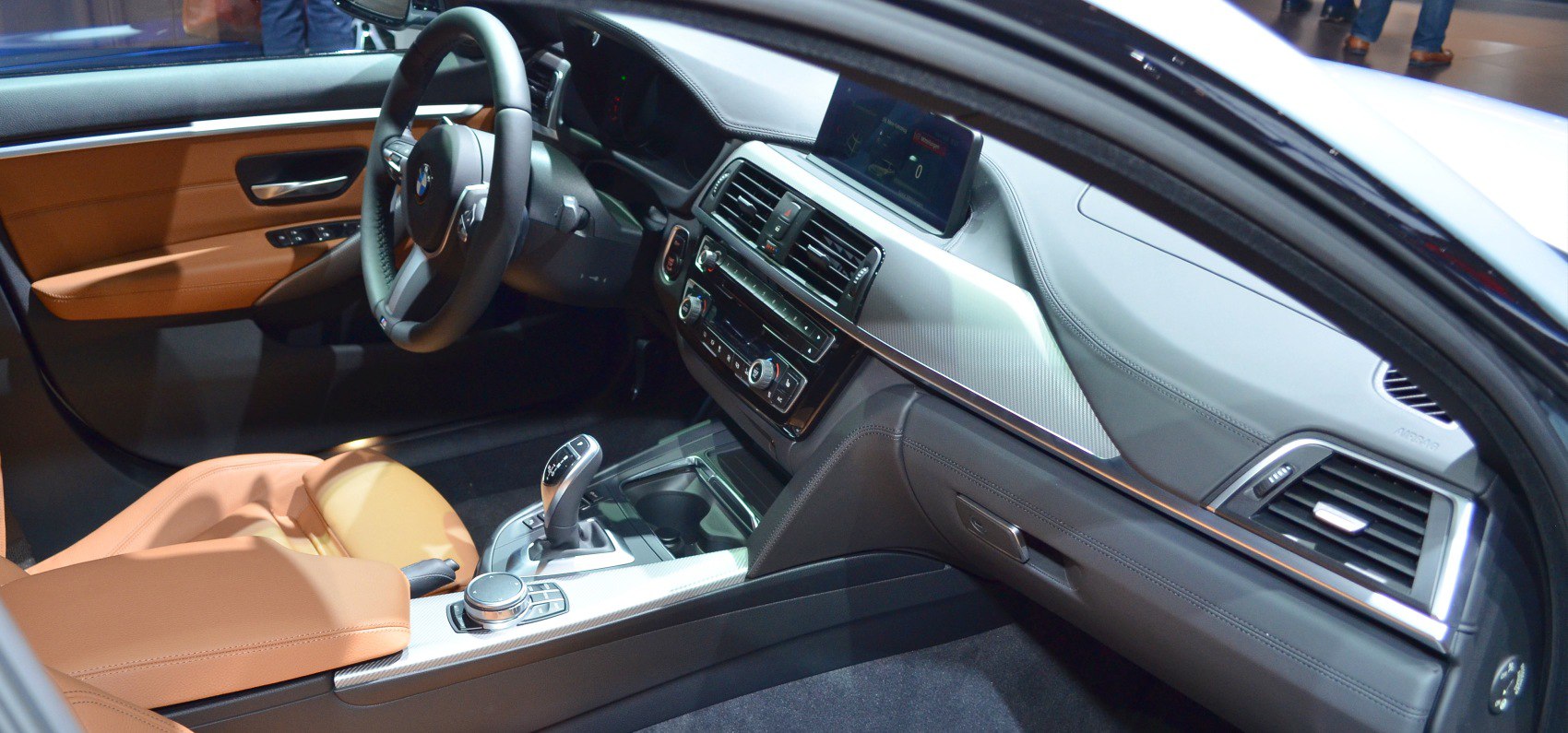 Dashboard with infotainment screen and tan leather seats