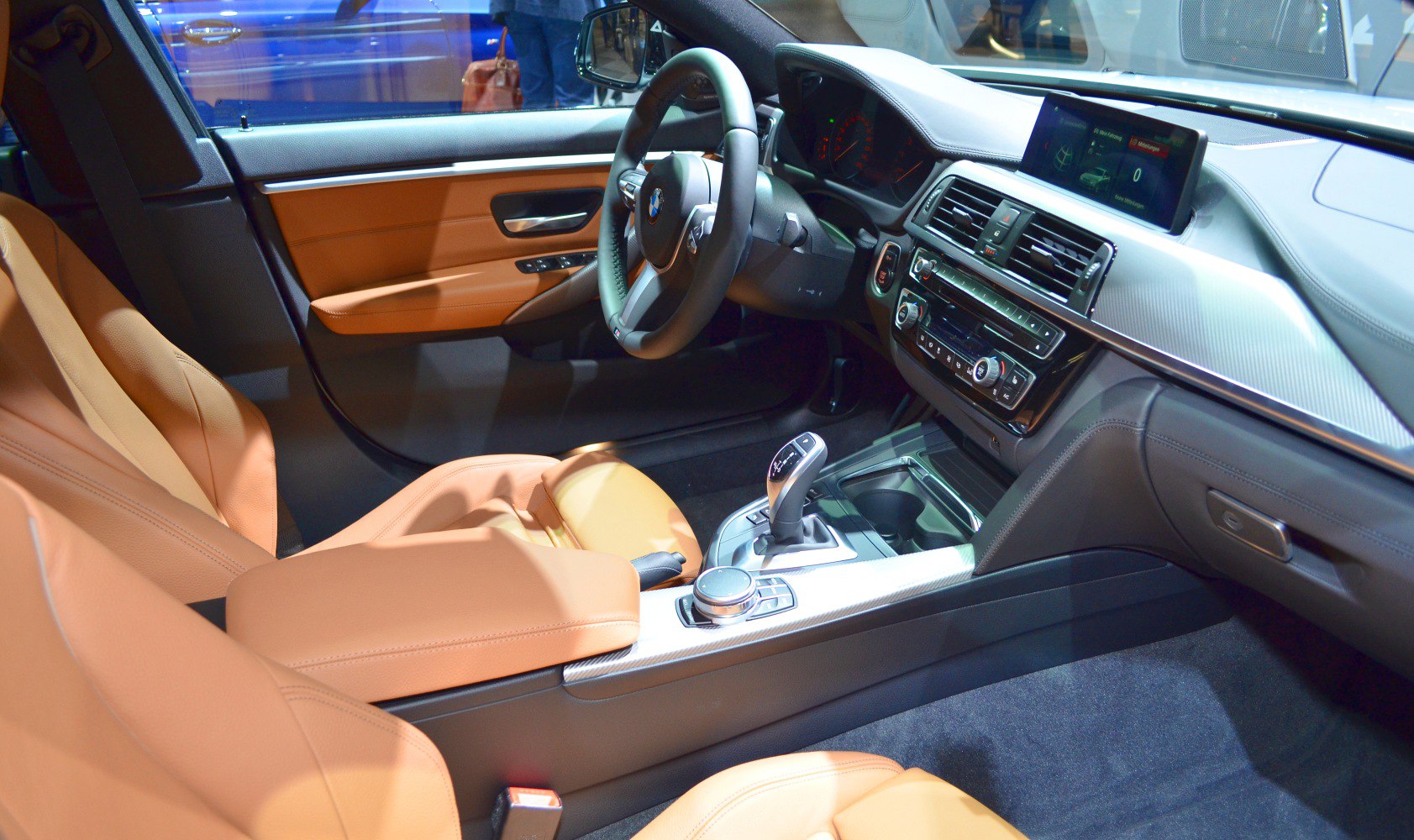 Luxury tan leather interior with modern dashboard and gear selector