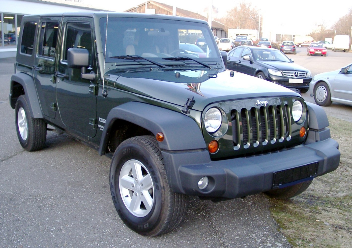 Front view of a 4-door SUV with distinctive vertical grille and round headlights