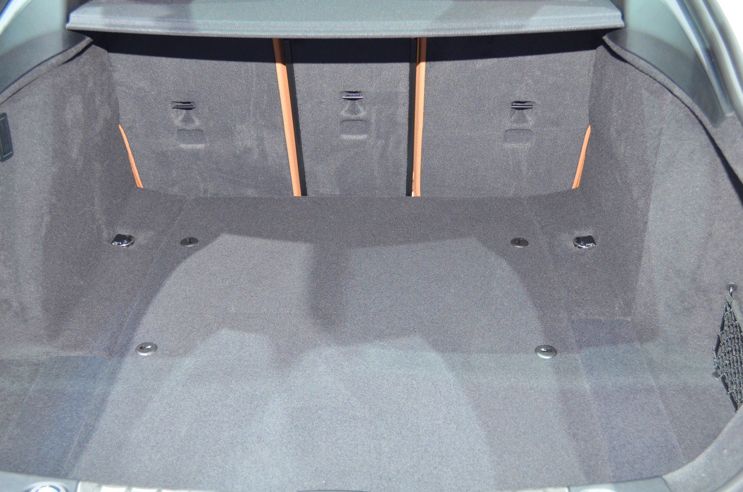 Spacious, carpeted trunk interior with fold-down seatbacks and cargo hooks