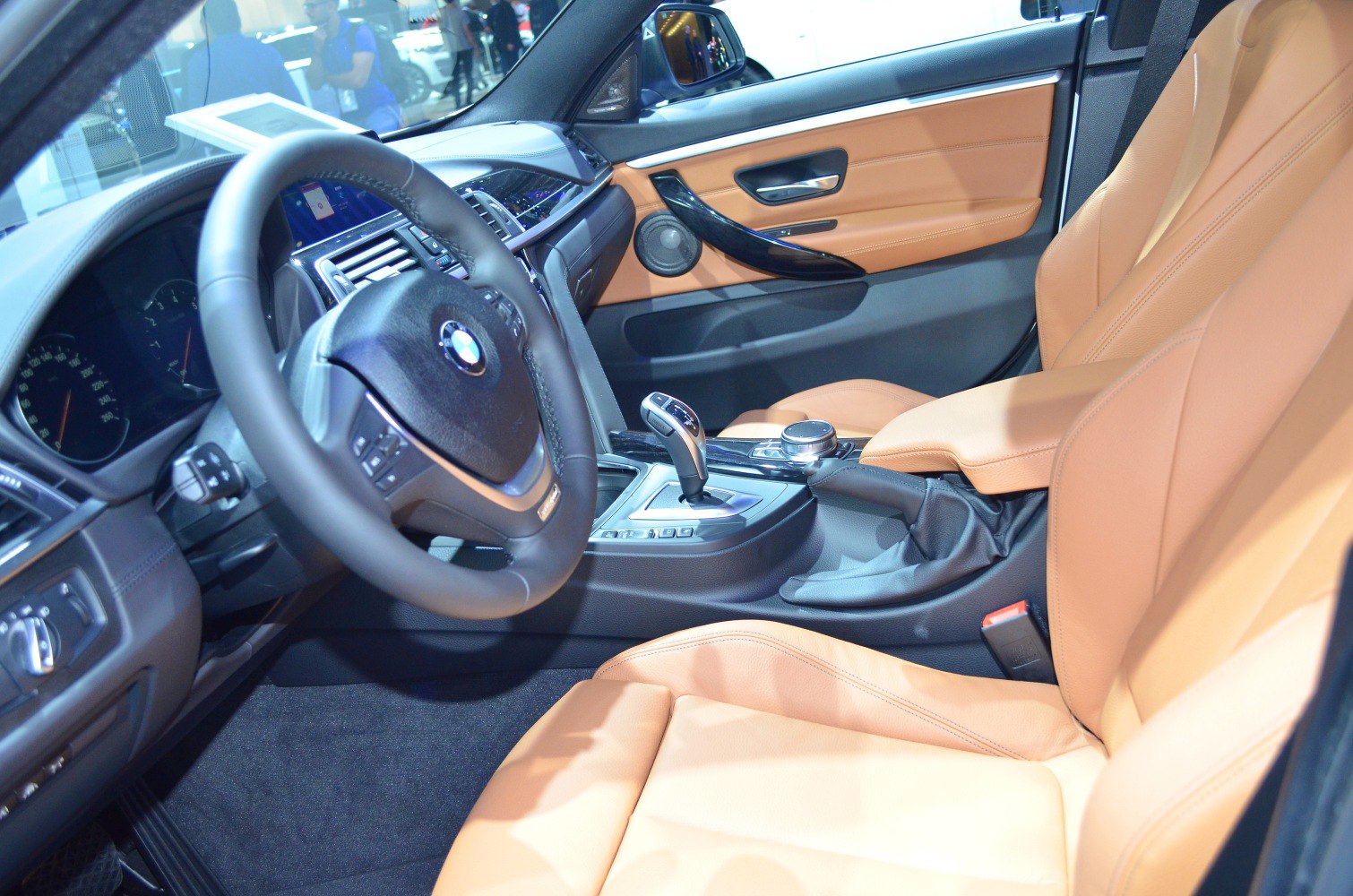 Luxury tan leather seats and modern driver controls interior