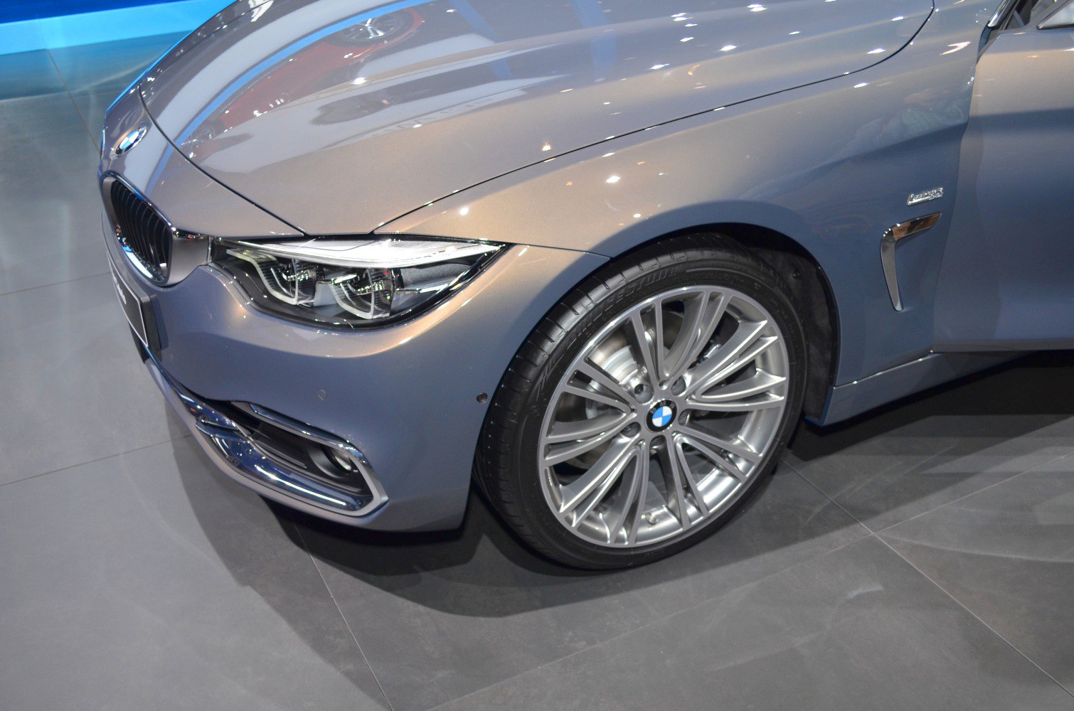 Front headlight and alloy wheel close-up