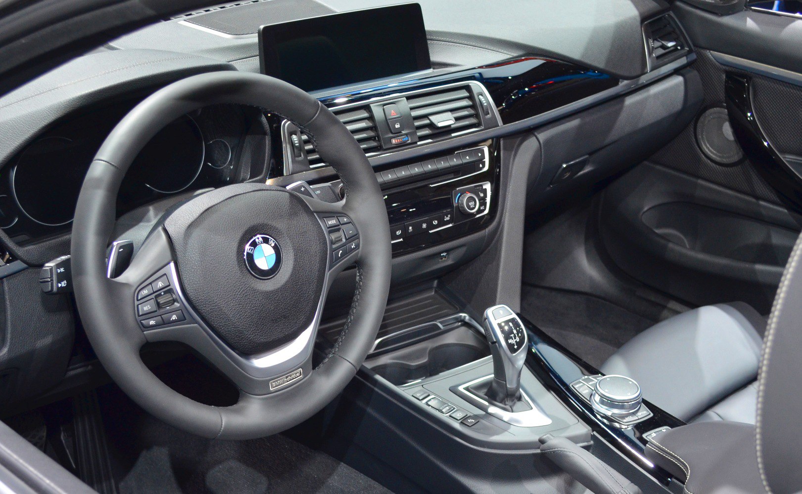 Modern BMW steering wheel, dashboard, gear shift and infotainment controls