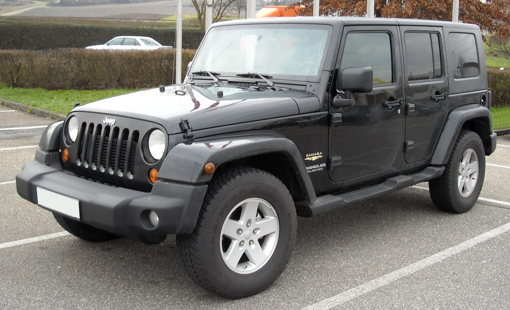 Black 4-door Jeep SUV with off-road design and rugged front grille