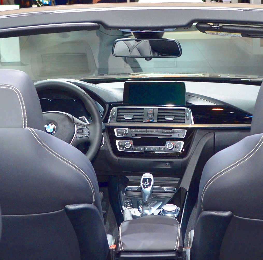 BMW Convertible interior with dashboard, infotainment screen, and gear shifter