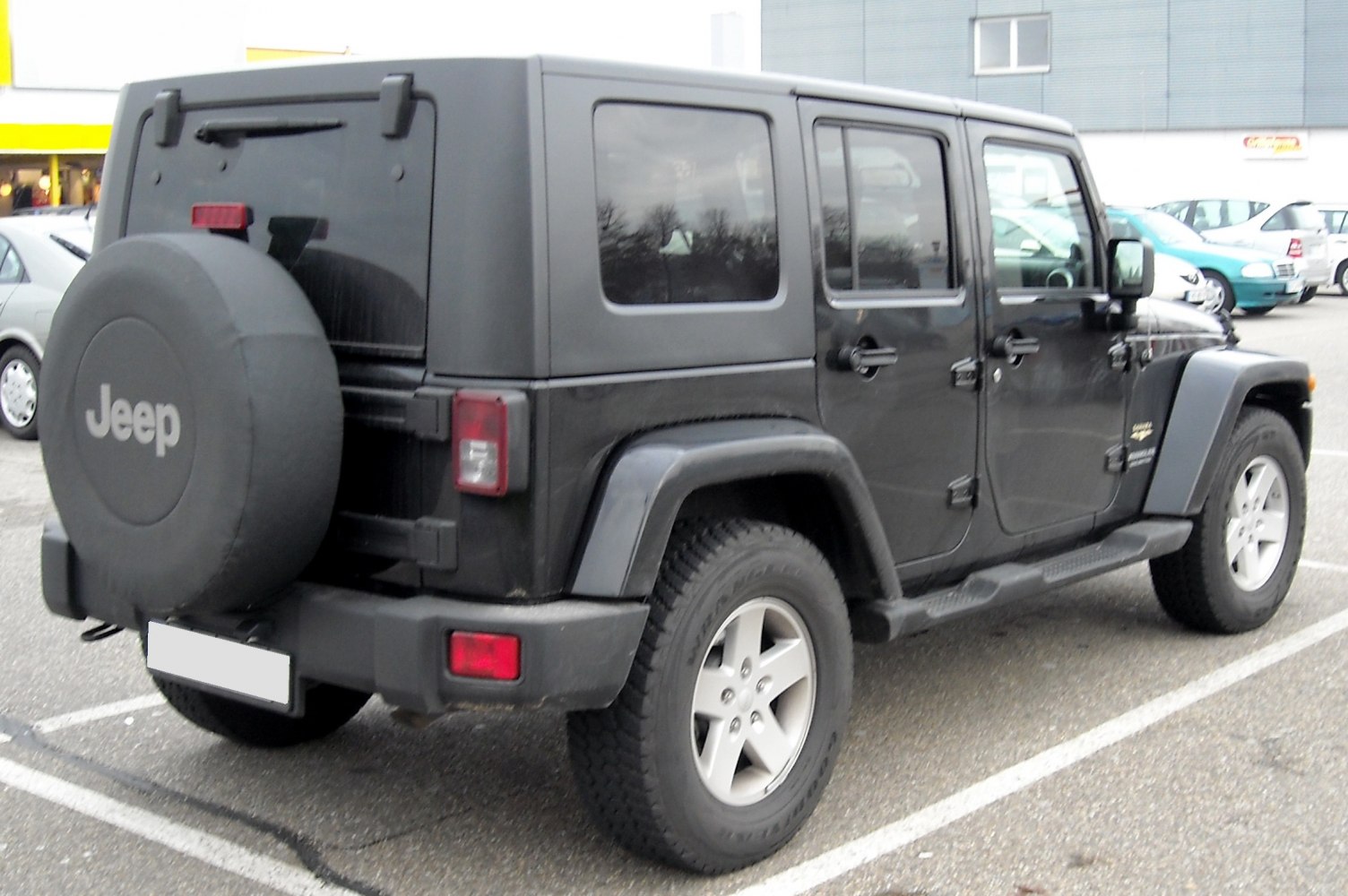 Rear side view with spare tire cover and rugged wheel arches