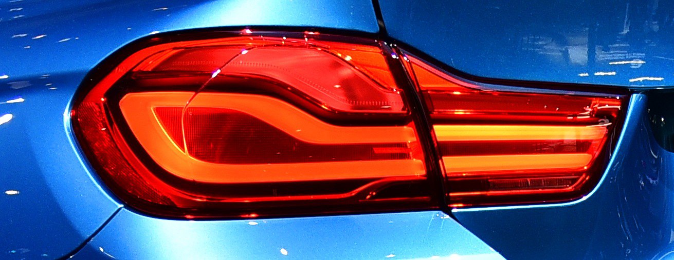 Close-up of a modern LED tail light with distinct horizontal lighting elements.